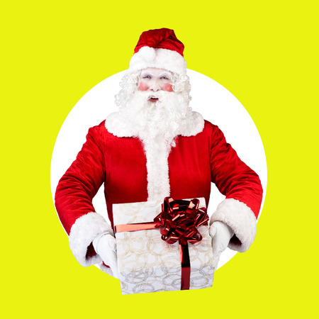 Santa Claus with gift posing on white green backgroundの写真素材