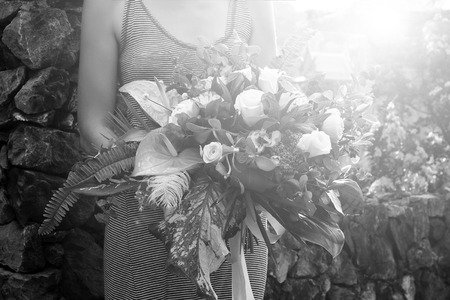 Bouquet of flowers in florist woman arms. Phuket, Thailandの写真素材