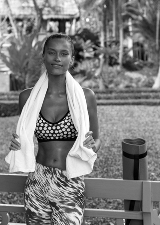 Sports woman in tropics with towel wearing stylish sportswear after training. Phuket, Thailandの写真素材