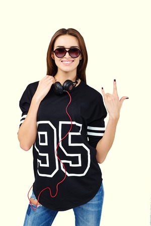 DJ with earphones in jeans and black shirtの写真素材