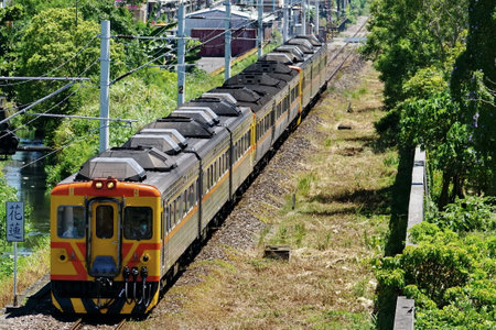 The train moves along the railroad tracks of the city of Kamakura