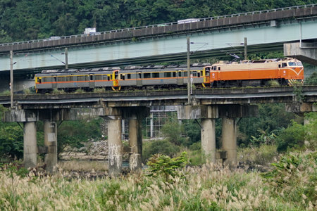 Train passing under the bridge in New Taipei City, Taiwan.の写真素材