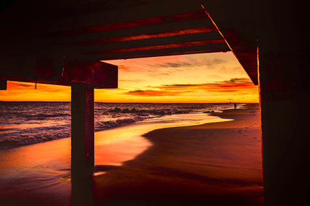 Opposite of Sunset at Beach with a beautiful sky from under the pierの写真素材