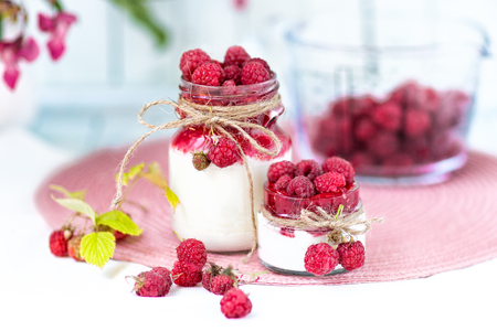 breakfasts, desserts. Yogurt with raspberry syrup and raspberry berriesの写真素材