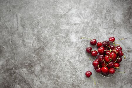 Background image , marble countertop and cherry berries . Summer season,harvesting berries ,jam,compotes.Space for labelling and advertisingの写真素材