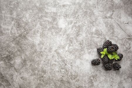 Background image , marble countertop and mulberry berries with mint leaves. Summer season,harvesting...