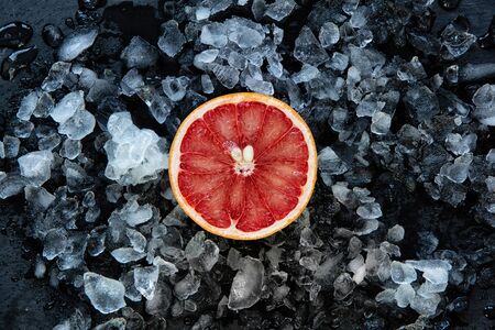 Grapefruit slices in ice dark keyの写真素材