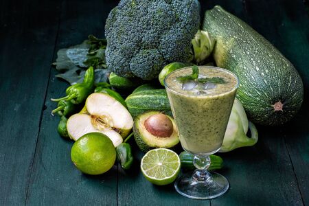 vegetarianism and a healthy lifestyle. green vegetables on a dark background. breakfast.Green vegetable drink-smoothieの写真素材