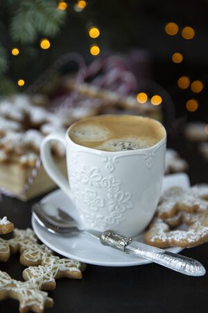Winter, holidays. Christmas table with coffee and cookies.decoration Christmas tree, lights .の写真素材