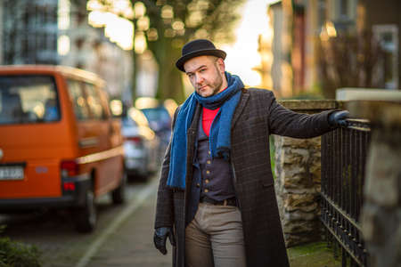 English style. A man walking through the streets of the city. Evening walk. Portraits of people.の写真素材