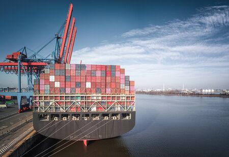 Aerial view of a container ship at the port of Hamburg at a terminal in sunny weatherの写真素材