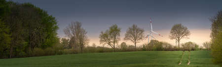 Panorama of field with renewable energy windmills in backgroundの写真素材