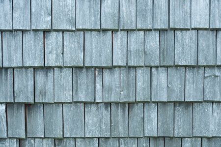 Uneven silver wooden shingles on a wallの写真素材