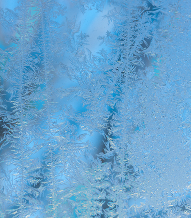 Blue frost patterns on a windowの写真素材