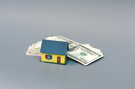 Little house and a stack of moneyの写真素材