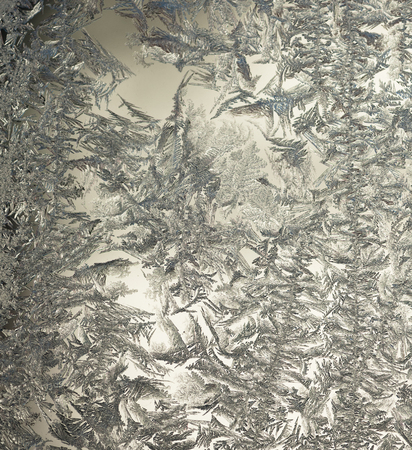 Frozen ice flowers on a windowの写真素材