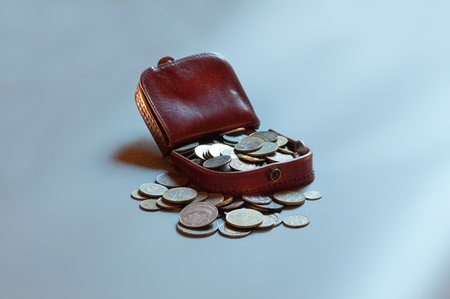 Leather wallet filled with coinsの写真素材