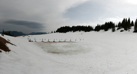 Clouds, mountains and an alpine pondの写真素材