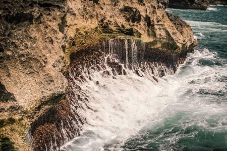 Big wave hitting rocks. Nature find its wayの写真素材