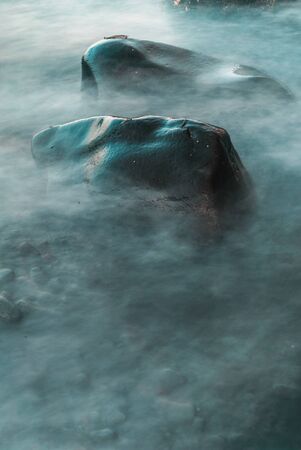 Wave hits rock with long exposure in Bali