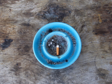 an Ashtray and Cigarette. a Smoking Place with a wooden tableの写真素材