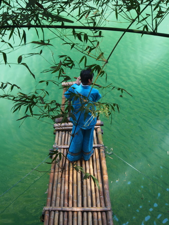 The Chinese Local Musician with Bamboo Tree and the river at the local village nearby three gorges dam. Travel in Yichang City, Hubei Province, China in 2014, 11th April.の写真素材