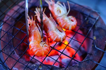 Grilled shrimp (Giant freshwater River prawn) grilling with charcoal at home, Natural Light in the evening. Bangkok, Thailand.の写真素材