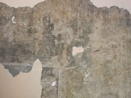 Old grunge concrete wall with removed white acrylic paint.Painting Preparation at homeの写真素材