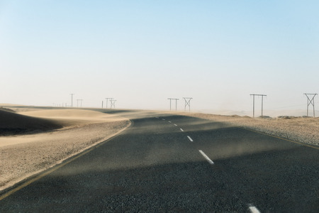 Sand Storm Across Lonely Desert Road in Southern Namibia taken in January 2018の写真素材