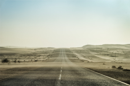 Sand Storm Across Lonely Desert Road in Southern Namibia taken in January 2018の写真素材