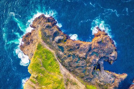 Top Down cliffs and coast line with waves breaking, post processed in HDRの写真素材