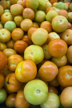 Close up a pile of fresh tomato in the marketの写真素材