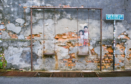 Street Art Mural tittled Children on the Swing painted by Louis Gan in Penang Unesco Heritage Site and it was painted in conjunction with the 2012 George Town Festivalのeditorial素材