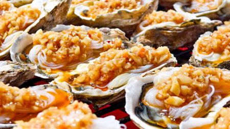 Close up of fresh oysters with seafood sauce Fried Oysters with Garlic Roasted oysters and...