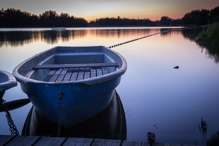 Reservoir at twilight with a boat in the foreground - Saxony, Germanyの写真素材