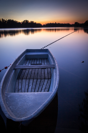 Reservoir at twilight with a boat in the foreground - Saxony, Germanyの写真素材