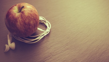 Music playing apple in which earphones are connectedの写真素材