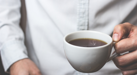 Take a break - man is holding cup of fresh coffeeの写真素材