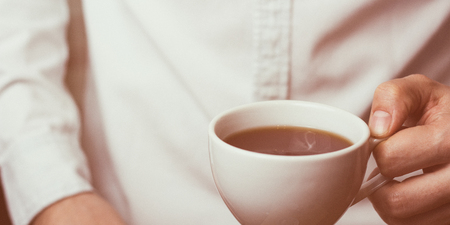 Take a break - man is holding cup of fresh coffeeの写真素材