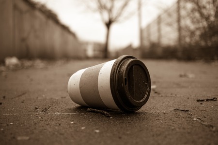 Used Coffee mug at sidwalk as symbol for pollutionの写真素材