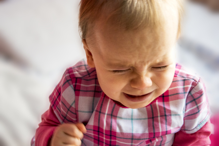 crying unhappy little child. little girl is flooding with tearsの写真素材