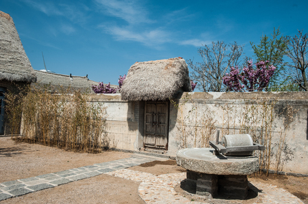 Stone mill in a house courtyardの写真素材