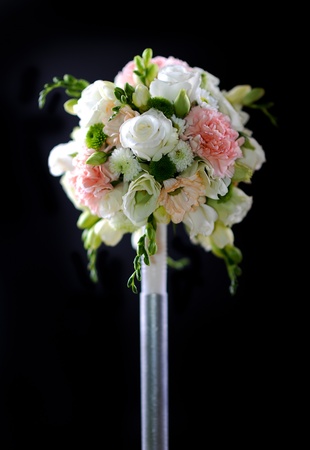 Decorative Plastic Flowers Bouquet on Dark Solid Background. Vertical Photo.の写真素材