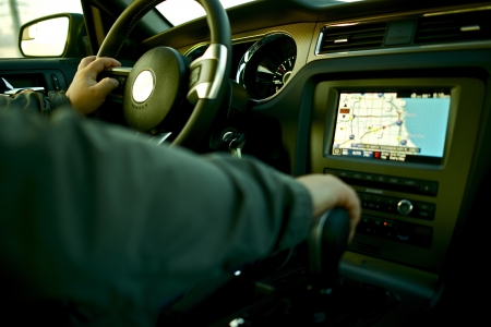 Car Navigation - Driving a Car with Navigation and Multimedia System. Car Interior with Male Driver.の写真素材