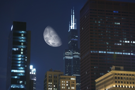 Night Hours in Chicago. Large Moon Between Skyscrapers. Urban Photo Collection.の写真素材