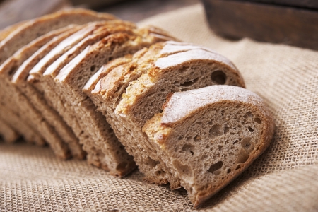 Fresh Sliced Rye Bread on Canvas and Wood.