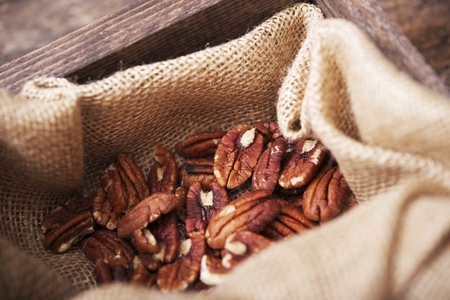 Pecans in Linen and Wooden Crate Closeup. Fresh Pecans.