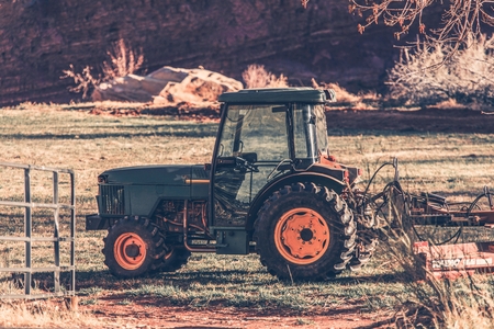 Small Tractor on the Field. Agriculture Machinery.