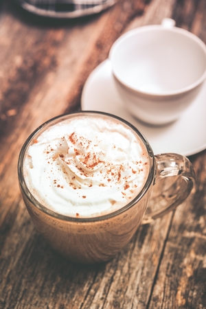 Fresh and Hot Chocolate Drink with Cream on Wooden Table の写真素材
