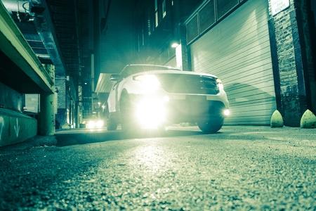 SUV Car in the Large American City Alley  Greenish Color Grading  Urban Theme の写真素材